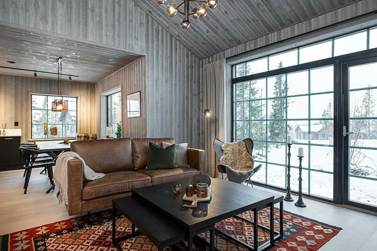A wooden house with a black design in the snow